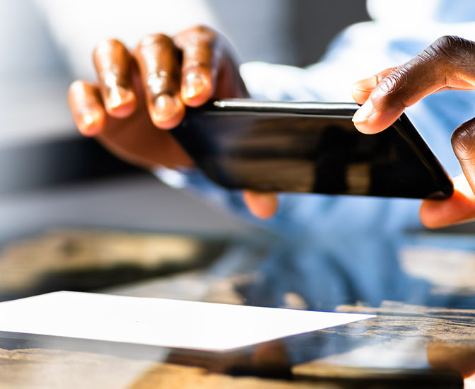 Person using their phone to deposit a check.