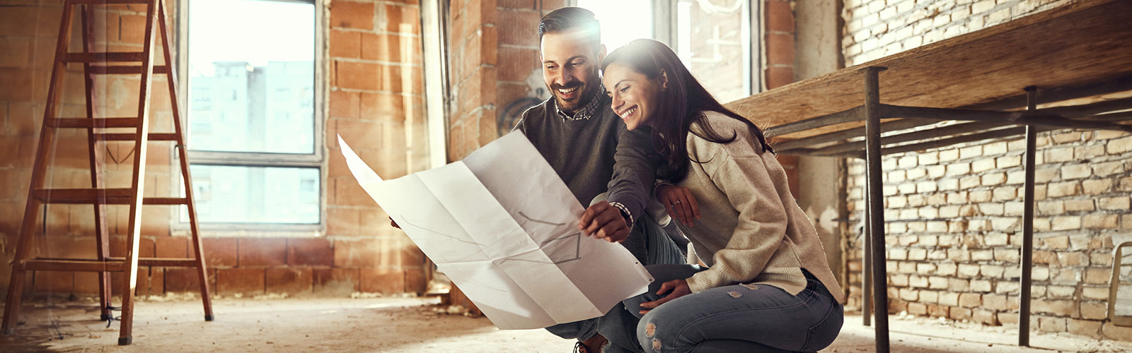 Couple looking at home renovation plans.