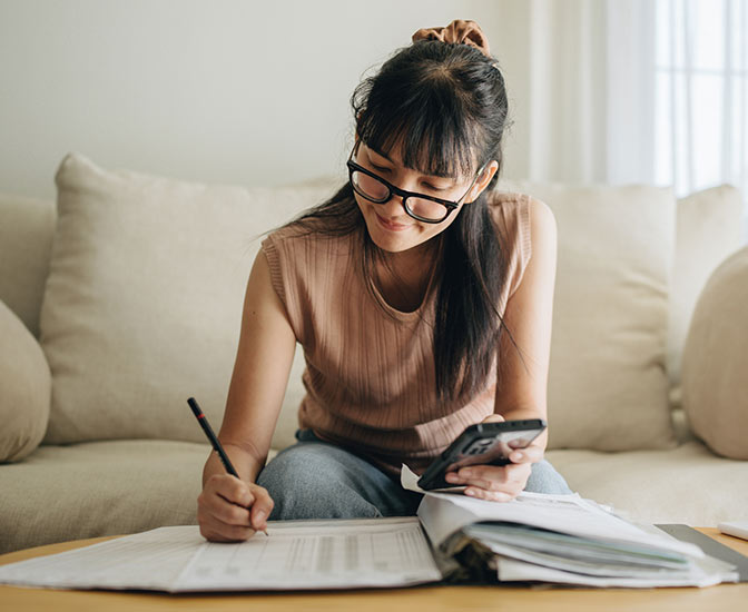 Person going through financials with their phone.