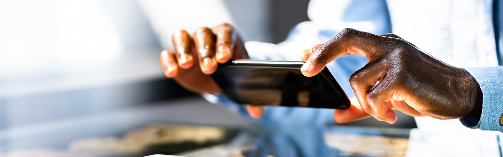 Person using a mobile phone to deposit a check.