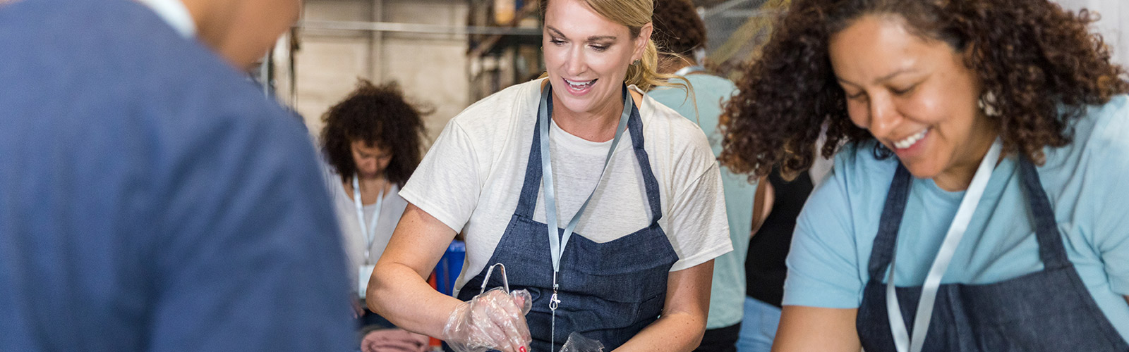 People service food at a community kitchen.